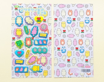 May include: Two sheets of colorful stickers featuring various cartoon characters and floral designs. The stickers include images of cats, bunnies, flowers, and other cute illustrations. The text on the stickers is in Korean.