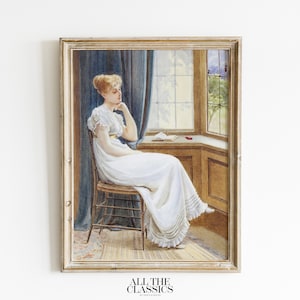 May include: A framed painting of a woman in a white dress sitting by a window. The woman is looking out the window and has her hand on her chin. The window is open and there is a view of trees and a building in the distance. The painting is in a light wood frame.