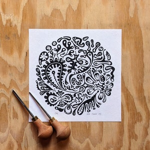 Op de afbeelding: Zwart-witte print van een abstract ontwerp met draaiende vormen en patronen. De print is op een witte achtergrond en is gesigneerd met "Jan Fawcett '23".