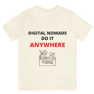 May include: A white t-shirt with black text that reads "DIGITAL NOMADS DO IT ANYWHERE". A black and white illustration of a person sitting in a beach chair with a laptop on their lap is below the text.