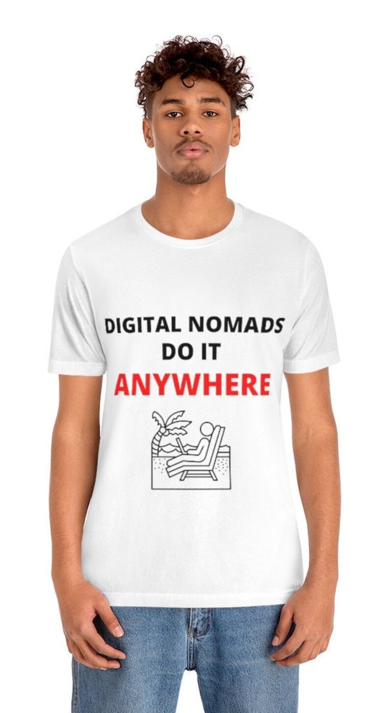 May include: White t-shirt with black text that reads "DIGITAL NOMADS DO IT ANYWHERE" and a black and white illustration of a person sitting on a beach chair with a laptop.