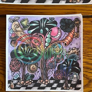 May include: A whimsical illustration of a tree with a purple background. The tree has a smiling mouth, a teacup, a key, and a clock. The text "Off with her head!" is written on a scroll. The tree is surrounded by a checkered pattern.