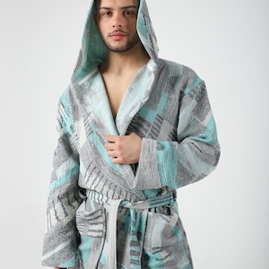May include: A hooded robe with a geometric pattern in shades of gray and teal.