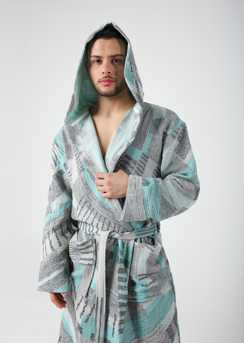 May include: A hooded robe with a geometric pattern in shades of gray and teal.