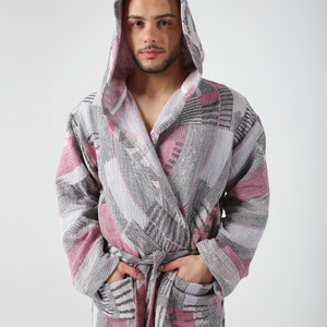 May include: A hooded bathrobe with a geometric pattern in shades of pink, gray, and white.