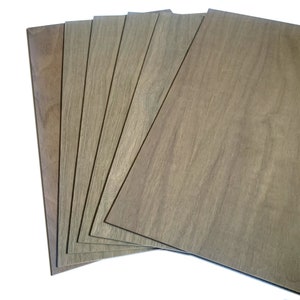 May include: A stack of six wood veneer sheets in a light brown color with a wood grain pattern.