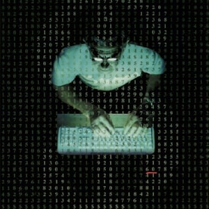 May include: A person wearing a blue shirt and glasses is typing on a keyboard. The background is a black and green grid of numbers. The text "Cracking the Code Third Edition" is at the top of the image.