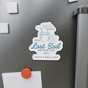 May include: A white sticker with blue text and illustrations. The sticker reads "Last Sail Before the Veil, Erica's Bach Trip, 2026." The design includes a cocktail, starfish, and umbrella.