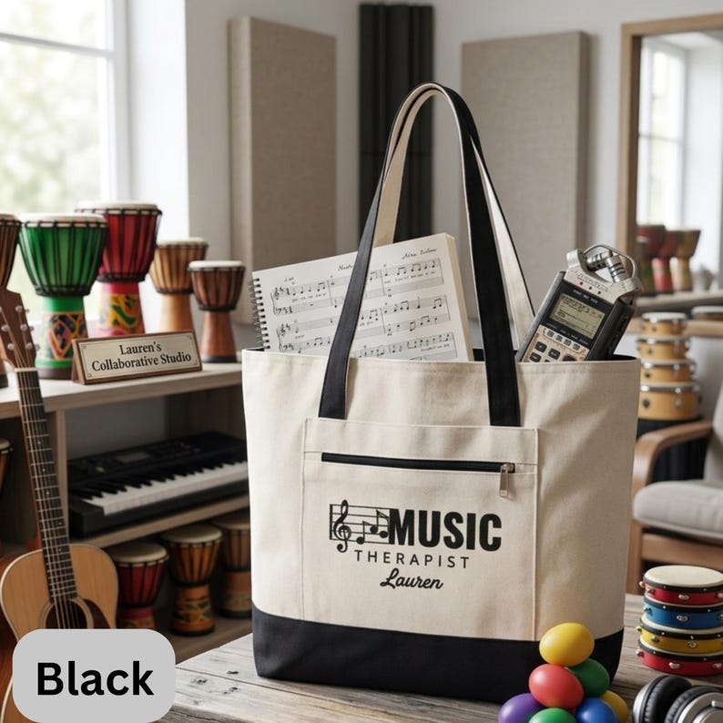 May include: A beige tote bag with black accents, featuring the text "MUSIC THERAPIST Lauren" in black. The bag contains sheet music and a digital recorder. Other musical instruments are visible in the background.