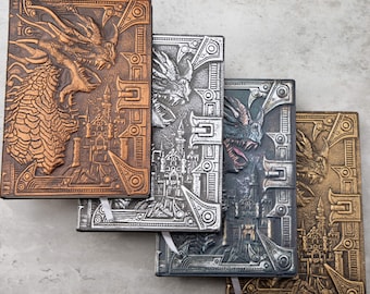 May include: Four leather-bound journals with embossed dragon and castle designs. The journals are in shades of copper, silver, and gold.