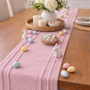 May include: A white ceramic mug with a black handle and the text "But First, Coffee" in a handwritten style. The mug is on a white surface. The mug is approximately 10 cm tall.