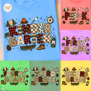 May include: A light blue t-shirt featuring the text KINDERGARTEN in large, patterned letters surrounded by camping icons like a tent, campfire, canoe, lantern, binoculars, and pinecone. Similar designs for other grades are shown in various colours.