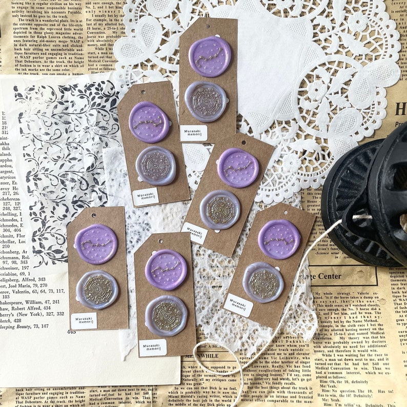 May include: Eight purple and gold wax seals with the text "Murasaki Memory" on each. The seals are on brown card stock.