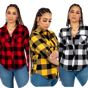 May include: Three women wearing long-sleeved plaid shirts in red and black, yellow and black, and white and black. The shirts have a button-down front and a chest pocket.