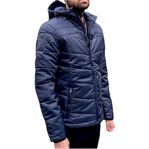 May include: A navy blue quilted jacket with a zipper closure and a hood. The jacket has a zippered pocket on the left side.