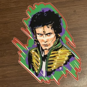 May include: A colourful sticker featuring a portrait of a person with dark hair, wearing a gold and green jacket with a purple and green background.