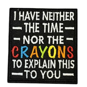 May include: Black square patch with white text: "I HAVE NEITHER - THE TIME - NOR THE - CRAYONS TO EXPLAIN THIS - TO YOU." The word "CRAYONS" is in colorful letters. The patch is likely for a jacket or bag.