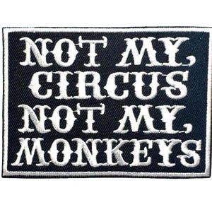 May include: A rectangular black and white embroidered patch. The patch features the phrase "NOT MY, CIRCUS, NOT MY, MONKEYS" in white, stylized lettering. The patch has a white border.