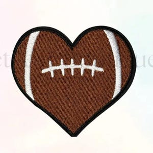 May include: A heart-shaped patch embroidered to resemble a football. The patch features a brown center with white stripes and stitching, outlined in black. The design is a creative blend of sports and affection.
