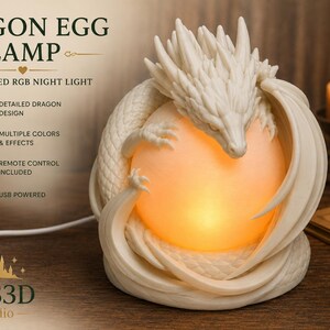 May include: A 3D printed off-white dragon egg lamp featuring a detailed dragon coiled around a glowing orange spherical light. The text reads DRAGON EGG LAMP, 3D PRINTED RGB NIGHT LIGHT, DETAILED DRAGON DESIGN, MULTIPLE COLORS & EFFECTS, REMOTE CONTROL INCLUDED, USB POWERED, and AUS3D Studio.