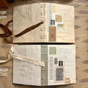 May include: Two open journals with brown and white fabric ribbons. The pages are filled with vintage ephemera, including tickets, stamps, and handwritten notes. The journals are labeled "Large Warm" and "Large Cool".