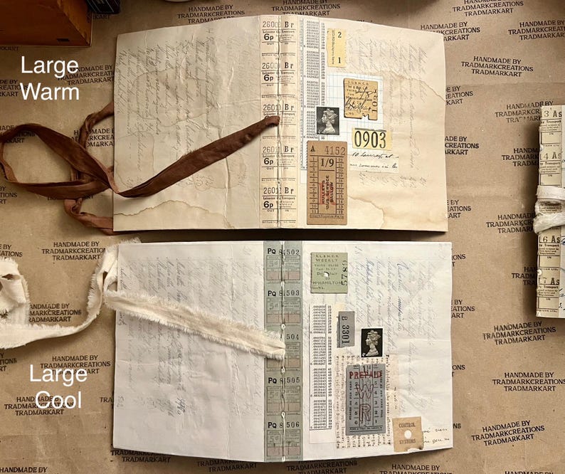 May include: Two open journals with brown and white fabric ribbons. The pages are filled with vintage ephemera, including tickets, stamps, and handwritten notes. The journals are labeled "Large Warm" and "Large Cool".