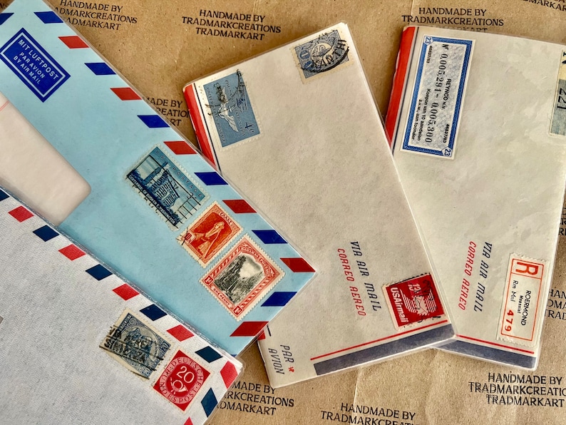 May include: Four vintage envelopes with red, white, and blue accents. The envelopes have stamps and markings in various languages, including "Via Air Mail" and "Mit Luftpost".