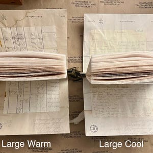 May include: Two stacks of vintage paper, one with a warm tone and the other with a cool tone. The paper is slightly yellowed and has a worn, aged look. The stacks are labeled "Large Warm" and "Large Cool".