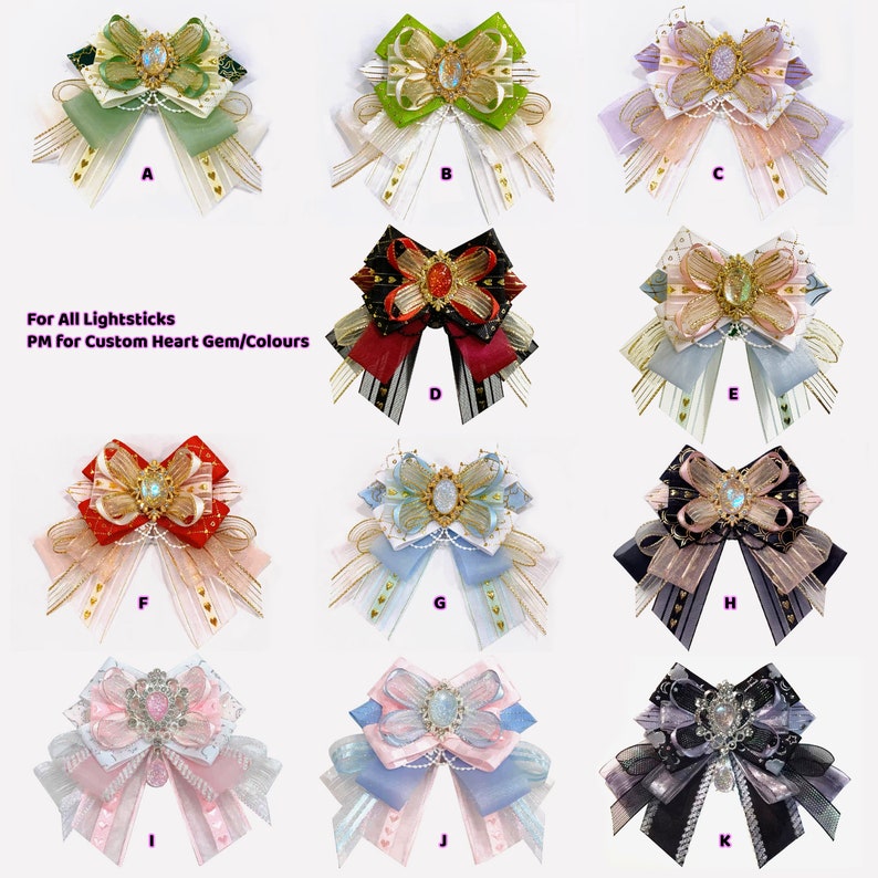 May include: Assortment of 11 handmade bows with various colors and patterns, including green, red, blue, pink, and black. Each bow features a decorative heart-shaped gem in the center. The text "For All Lightsticks PM for Custom Heart Gem/Colours" is displayed below the bows.