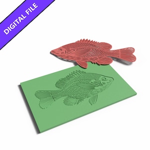 May include: A red, intricate, laser-cut fish silhouette positioned above a rectangular green plate featuring an identical embossed fish design. The image includes a purple diagonal banner in the upper left corner with the text DIGITAL FILE.