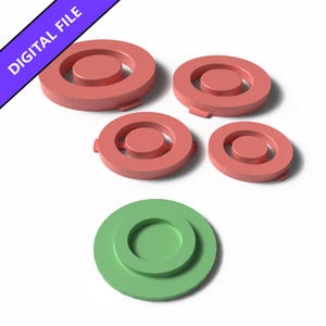 Peut inclure: Un fichier numérique contenant cinq objets circulaires à dessus plat avec un anneau central surélevé. Quatre objets sont de couleur saumon et un est vert clair. Chaque pièce présente une petite languette sur le bord extérieur, en rendu 3D.