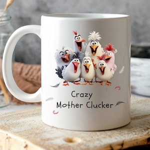May include: White ceramic mug featuring a humorous cartoon image of a group of chickens with the text "Crazy Mother Clacker".