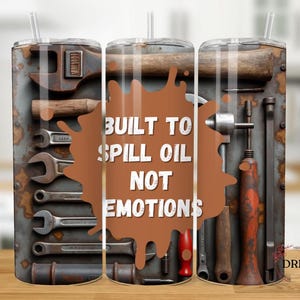 May include: Three stainless steel tumblers with a brown splatter design and the text "Built to Spill Oil Not Emotions". The tumblers are decorated with images of tools, including wrenches, hammers, and screwdrivers.