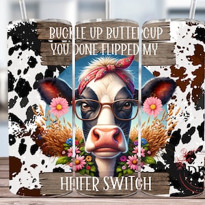 May include: A black and white cow with a red bandana and glasses is featured on a tumbler with the text "Buckle Up Buttercup You Done Flipped My Heifer Switch". The tumbler has a black and white cow print background.