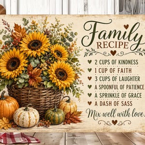 May include: A rectangular sign featuring a woven basket filled with yellow sunflowers and autumn leaves, surrounded by three pumpkins. The text reads: Family RECIPE, 2 CUPS OF KINDNESS, 1 CUP OF FAITH, 3 CUPS OF LAUGHTER, A SPOONFUL OF PATIENCE, A SPRINKLE OF GRACE, A DASH OF SASS, Mix well with love!