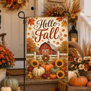 May include: A rectangular garden flag featuring the text Hello Fall in dark red script. The design displays a red barn behind a white fence, surrounded by orange pumpkins, yellow sunflowers, and scattered autumn leaves on a cream background.