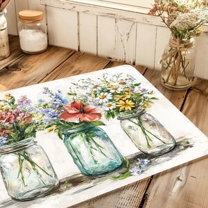 May include: A rectangular decorative mat featuring a watercolor painting of three mason jars filled with colorful wildflowers. The jars are clear with silver lids, and the flowers include red, yellow, blue, and purple blooms.