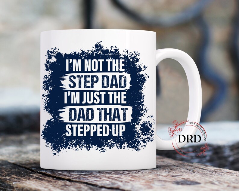 May include: White ceramic mug with a blue and white design. The text on the mug reads "I'm not the step dad I'm just the dad that stepped up".
