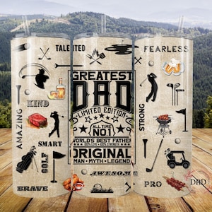 May include: A beige tumbler with a golf theme, featuring the text "Greatest Dad" and golf-related illustrations. The design includes golf clubs, a golf cart, and food icons. The tumbler has a straw and is set against a scenic background.