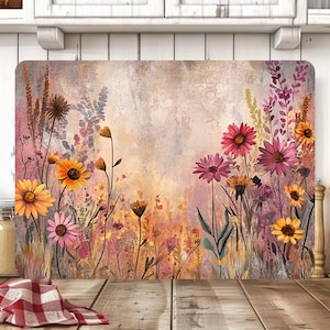 May include: Rectangular chopping board with a watercolour floral design. The artwork features vibrant yellow, pink, and purple flowers against a soft, textured background. A kitchen accessory.