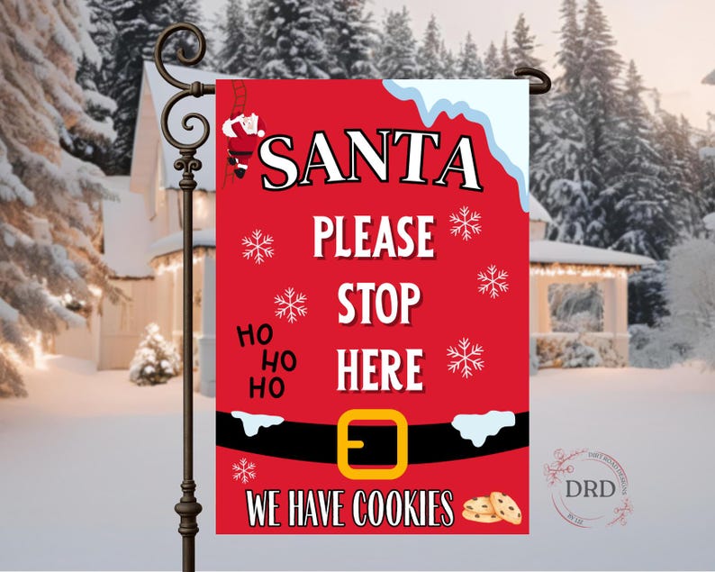 May include: A red Christmas garden flag with the words "SANTA PLEASE STOP HERE" in white. The flag features a Santa belt design with a gold buckle, snowflakes, and the text "WE HAVE COOKIES". A decorative garden stake holds the flag.