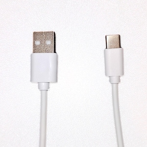 May include: A white USB cable with a standard USB connector on one end and a USB-C connector on the other end.
