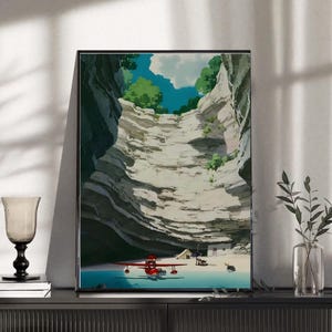 May include: A framed art print depicting a scenic landscape with a red seaplane on a beach. The artwork showcases a canyon with a blue sky and green foliage. The print is displayed on a black cabinet with decorative items.
