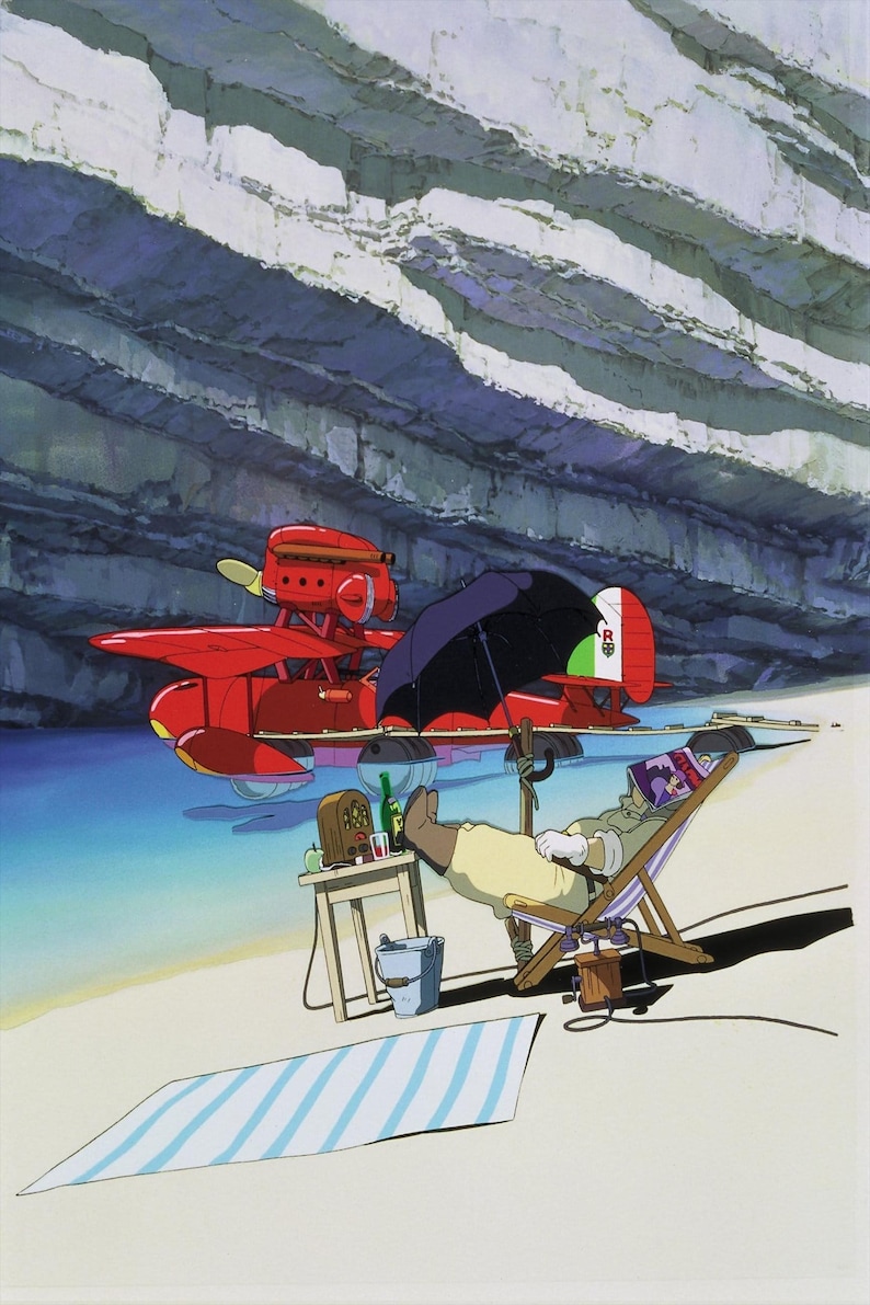 May include: An animated scene depicts a red seaplane with an Italian flag on its tail, parked near a beach. A person relaxes in a beach chair under a black umbrella, with a radio and drinks on a small table. A striped towel lies on the sand.