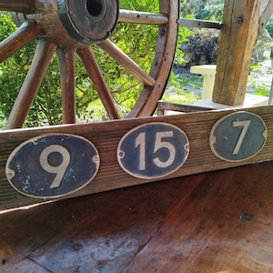 Vintage flea market house entrance plaque on a blue background numbered 5 15 and 9 in relief cast aluminum artisanal decoration furnishing art
