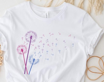 May include: White t-shirt with a design of three pink and blue dandelions with seeds blowing in the wind.