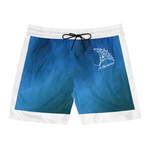 May include: Swim shorts featuring a blue gradient background with white side panels and a black drawstring. A white graphic of a manta ray with intricate tribal-style patterns is printed on the right side, accompanied by the text El Mantarraya.