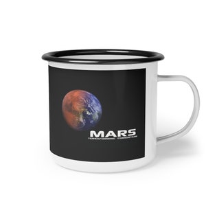 May include: White enamel mug with a black rim and handle. The mug features a black background with a red and blue image of Mars and the text "MARS TERRAFORMING CONSORTIUM".