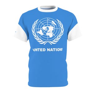 May include: A blue t-shirt with a white design of the United Nations logo and the words "UNITED NATIONS".