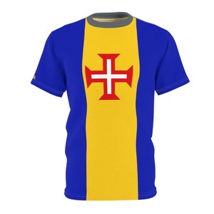 May include: A blue and yellow t-shirt with a red cross on the front. The cross is the symbol of the flag of the Azores.